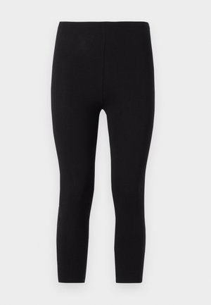 Leggings noirs en tissu extensible. Dotés d'une taille sans couture et d'un design ajusté à longueur de cheville avec une texture lisse.