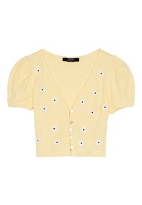 Cardigan court jaune avec manches ballon, col en V et cinq boutons à l'avant. Présente une broderie de fleurs blanches avec des centres noirs sur le devant.