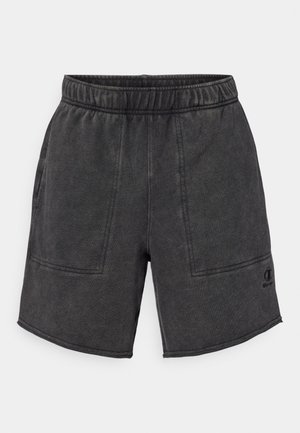 Schwarze Baumwollshorts mit einem elastischen Bund, zwei Vorderaschen und einem Logoelement am unteren Saum. Sie haben eine glatte Textur und eine lässige Passform.