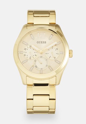 Montre en acier inoxydable doré avec un cadran texturé, trois sous-cadrans et un bracelet en maillons. Présente un grand 12 en haut.