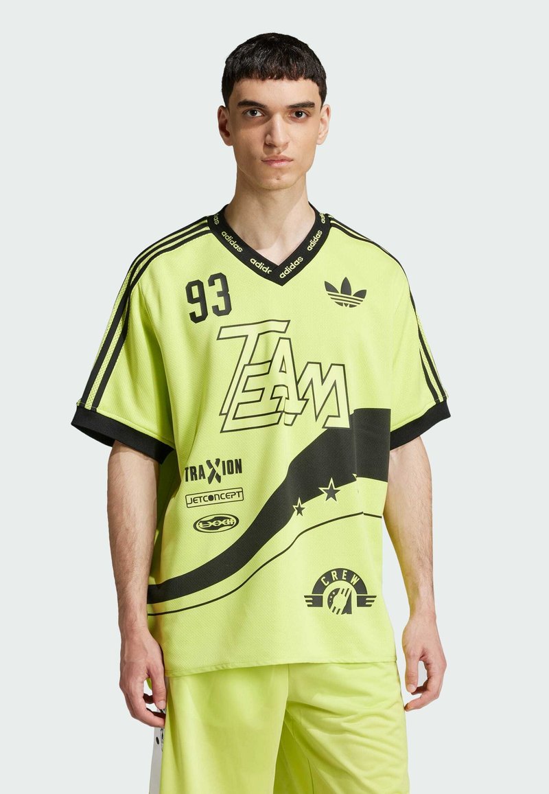 Neon geltonas per didelis džersis su juodomis akcentais, grafikos spauda ir "93" priekyje. Turi V formos iškirptę ir trumpas rankoves. Tekstūruotas audinys.
