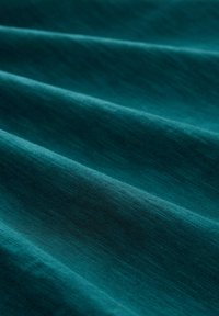 Material de culoare teal cu o textură fină, care prezintă o strălucire subtilă și ondulații delicate. Aspect ușor și ușor translucida.