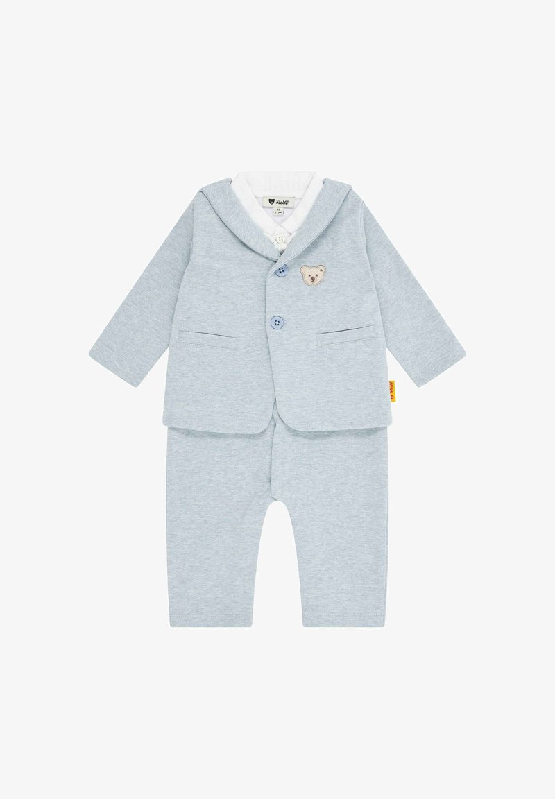 Hellblaue Baumwolle-Jumpsuit mit Blazer-Design, ausgestattet mit einem Bären-Patch, zwei Knöpfen und zwei vorderen Taschen. Weicher Stoff, lässige Passform.