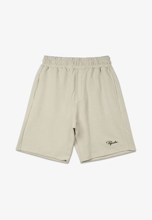 Khaki sort egy texturált anyagból, rugalmas derékpánttal, oldalsó zsebekkel és fekete logóval a bal alsó oldalon.
