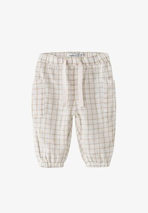 Hvite og beige rutete pysjamasbukser med elastisk midje, snøring og to sidelommer. Laget av lett, teksturert stoff.