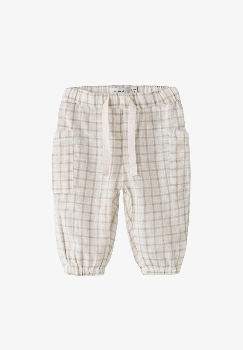 Białe i beżowe w kratkę spodnie piżamowe z elastycznym pasem, sznurkiem i dwoma bocznymi kieszeniami. Wykonane z lekkiego, teksturowanego materiału.