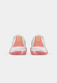 Λευκά και ροζ αθλητικά παπούτσια για τρέξιμο με υφασματική πίσω πλευρά, πράσινο λογότυπο και λευκή ενδιάμεση σόλα. Η σόλα διαθέτει εγκοπές για καλύτερη πρόσφυση.