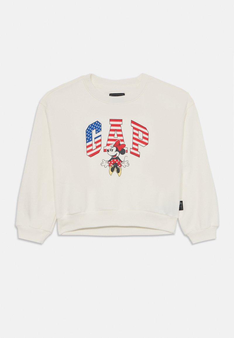 Witte sweatshirt met een grafisch ontwerp van "GAP" in vetgedrukte letters, een Amerikaanse vlag en een cartoonfiguur met een rode strik en stippen.
