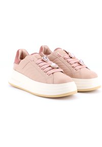 Sneaker in pelle rosa con lati testurizzati, dettagli in peluche e charms decorativi per i lacci. Suola bianca spessa con parte inferiore di un leggero color tan.
