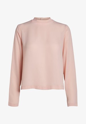 Blusa a maniche lunghe rosa chiaro con collo alto, texture morbida, taglio dritto e discreta cerniera sul retro.