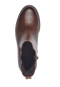 Botte de cheville en cuir brun avec une texture lisse, bout rond et fermeture éclair sur le côté avec une petite languette. Intérieur doublé d'un matériau doux.