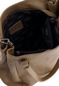 Beige leather handbag with a textured finish. Features an interior zip pocket and branded fabric lining. Includes adjustable shoulder strap.