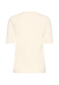 Haut en tricot couleur crème à manches courtes avec un col rond, vu de dos sur un fond blanc uni.