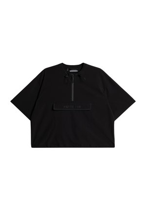 Black oversized short-sleeve top with a high neck, front zip closure, and a large chest pocket featuring the brand name embossed.