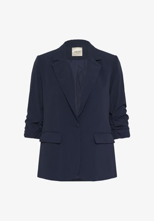 Tumesinine bleiser pehmest kangast, millel on üks nupp, terav kaelus ja üleskeeratud varrukad koos kahe esise liigese taskuga.