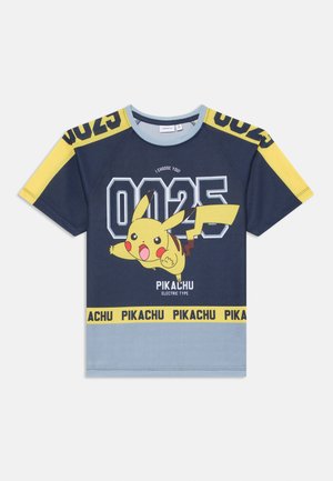 T-shirt blu navy con dettagli gialli, caratterizzato da una grafica di Pikachu, "0025" e il testo "I choose you!" in colori a contrasto. Dettaglio di tipo elettrico in basso.
