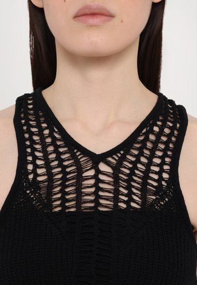 Black knitted tank top featuring a v-neck design with open weave patterns and textured details on the bodice.