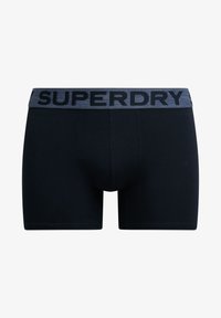 Boxer intramontabili neri in cotone, con una vita elastica grigia decorata dal logo "SUPERDRY" in nero. Design semplice e forma aderente.