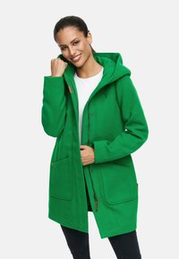 Green hooded coat made of soft fabric, featuring a button closure, two front pockets, and a logo detail on the chest.