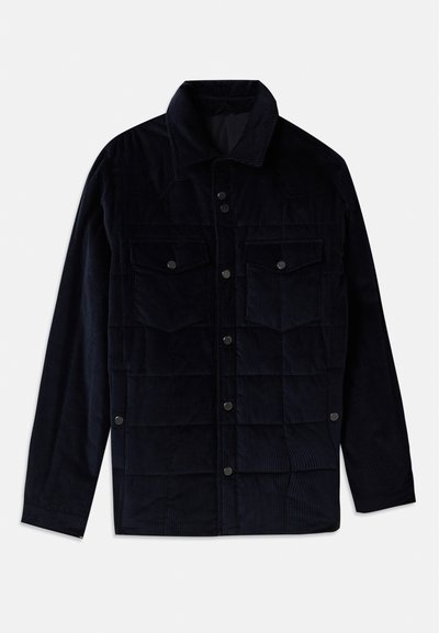 Marinefarbener Cord-Jacke mit Druckknopfverschluss, zwei Brusttaschen und einem strukturierten Rautenmuster. Mit Hemdkragen und langen Ärmeln.