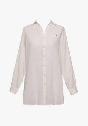 Λευκό λινό πουκάμισο με κουμπιά, μακριά μανίκια, κλασικό γιακά και ένα κεντημένο λογότυπο στο στήθος. Μαλακή υφή, άνετη εφαρμογή.