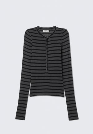 Black and grey striped long-sleeve top with a round neckline and a button placket in the front. Soft fabric with a fitted design.