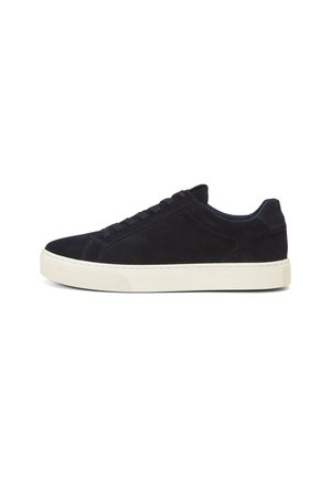 Suede sneaker in dark navy with a rounded toe. Features flat laces, a cushioned collar, and a textured, cream-colored rubber sole.