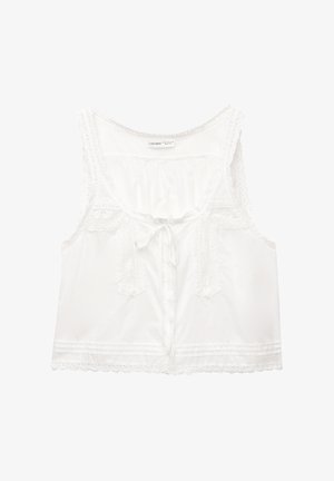 Blusa bianca senza maniche con bordo in pizzo, chiusura frontale con cravatta e dettagli decorativi con bottoni sul corpetto, dal taglio morbido.