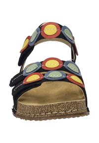 Schwarze Sandale mit mehreren farbigen runden Akzenten in Rot, Gelb und Grün. Verfügt über eine Korksohle und Riemen für einen sicheren Sitz.
