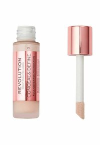 Fuld dækning flydende foundation i en klar glasflaske med en frostet beige finish og en roseguld hætte. Har en flad applikator.