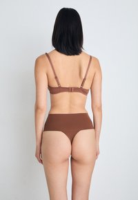 Spanx SPANXSUPERSMOOTH™ UNDIE-TECTABLE® THONG - String - hickory