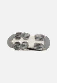 Athletic shoe outsole featuring a grey rubber design, textured with herringbone patterns, and a white midsole.