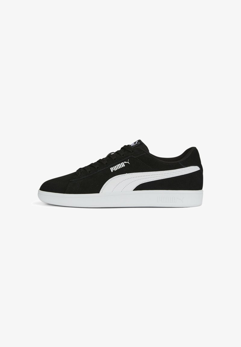 Black suede sneakers with white accents, featuring a thick white rubber sole and a prominent Puma logo on the side and tongue.