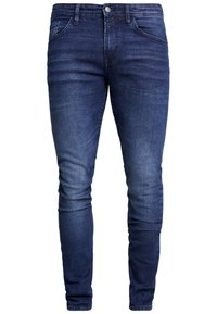 Jeans de mezclilla azul oscuro con un corte ajustado, cinco bolsillos y cremallera. La tela tiene una textura suave con un ligero desgaste en los muslos.