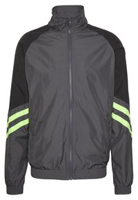 Black and gray windbreaker jacket with a high collar, zip front, elastic cuffs, and two green stripes on sleeves. Lightweight, sporty design.