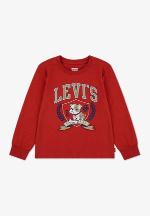 Raudona ilgomis rankovėmis marškinėliai iš medvilnės su šuns grafika, "LEVI'S" tekstu ir dekoratyviniais lauro akcentais. Žymė šone.