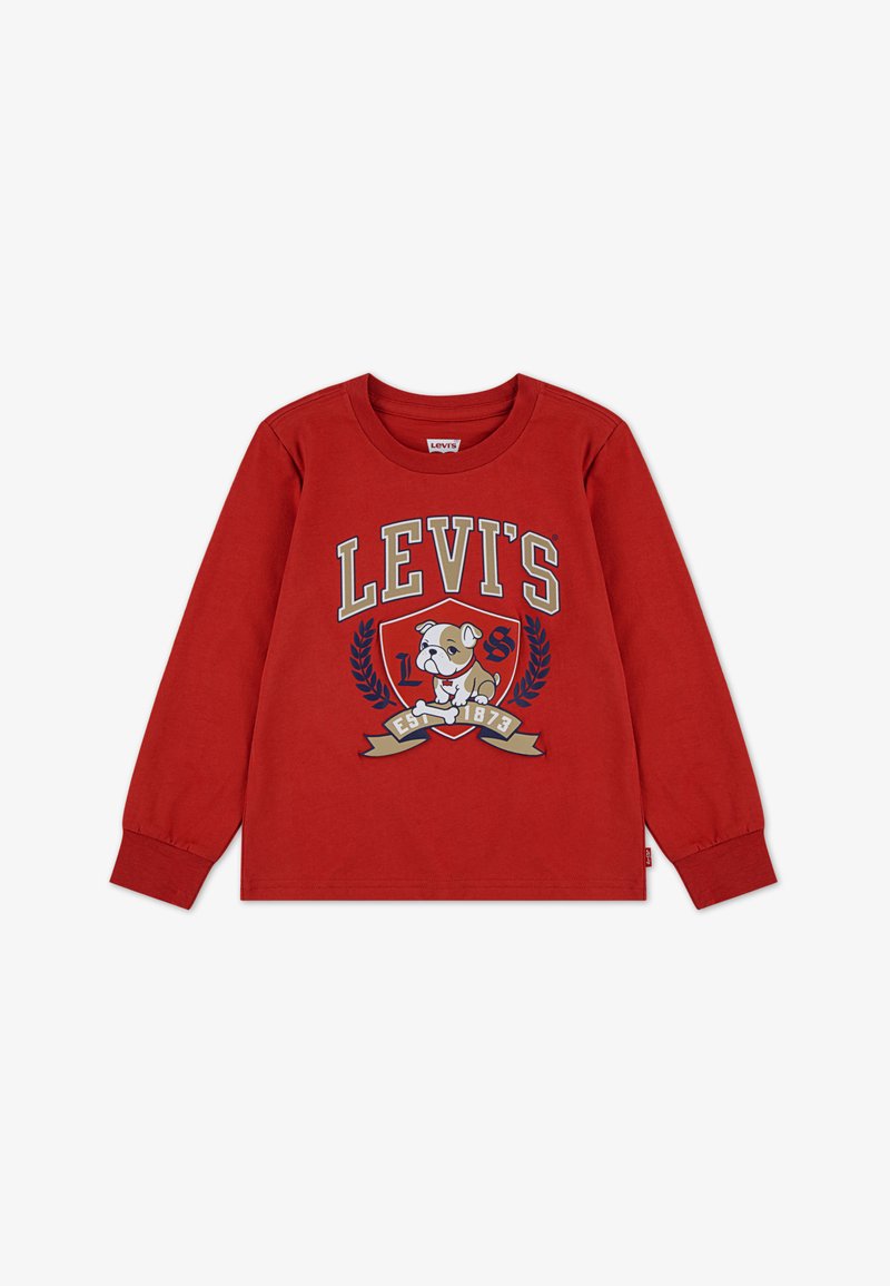 Punainen pitkähihaisten t-paita, joka on valmistettu puuvillasta ja jossa on koiran grafiikkaa, "LEVI'S" -teksti ja koristeelliset laakeriseppeleet. Tunnus kyljessä.