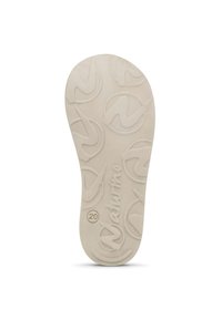 Cream-colored shoe insole with a textured surface featuring circular patterns and the word "naturino" embossed near the heel.