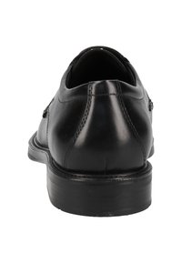 Chaussure habillée en cuir noir avec une finition lisse, bout rond et talon bas. Comprend des coutures discrètes et un intérieur rembourré.