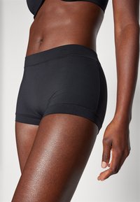 Black athletic shorts with a smooth texture, featuring a wide waistband and a snug fit, designed for comfort and flexibility during movement.
