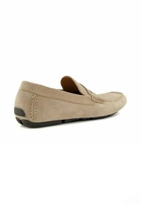 Beige suede loafers with a rounded toe, decorative stitching, and black rubber sole. The back features a subtle accent and slip-on design.