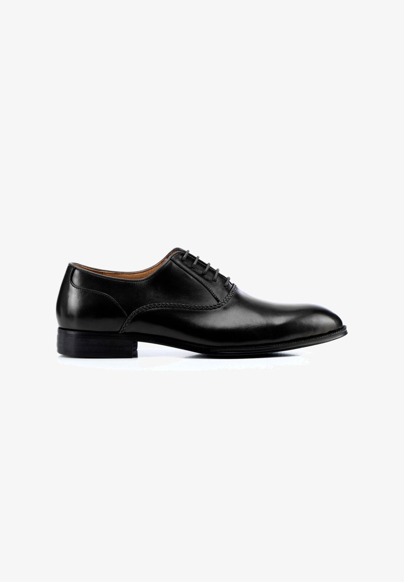 Chaussure habillée en cuir noir avec une finition lisse, un bout rond et un laçage à six œillets. Présente un subtil détail de couture et un talon bas empilé.
