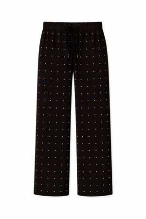 Μαύροι φαρδιοί παντελόνες με ελαστική μέση, κορδόνια και σχέδιο από μικρές χρυσές τελίτσες, ομοιόμορφα τοποθετημένες.