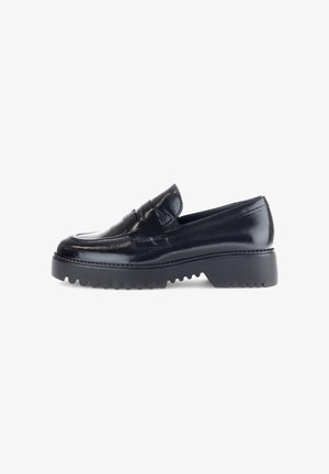 Black patent leather loafer with a rounded toe, featuring a raised stitch pattern and a thick, textured black rubber sole.