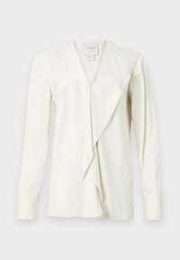 Blusa bianca a maniche lunghe con scollo a V, davanti drappeggiato e tessuto testurizzato. Presenta maniche aderenti e una leggera lucentezza.