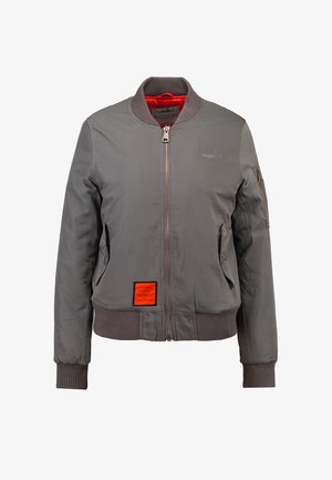 Gray bomber jacket made of smooth fabric, featuring ribbed cuffs and hem, front zipper, and an orange label on the left side. Lined in red.