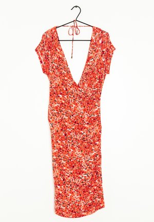Red-orange floral wrap dress with short sleeves and deep V-neck hung on a black hanger against a white background.