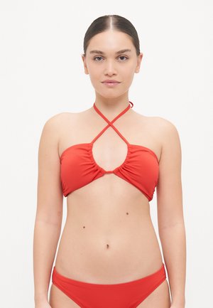 Red bikini set made of smooth fabric. Top features a gathered front with a crisscross strap design. Bottom is a simple, classic cut.