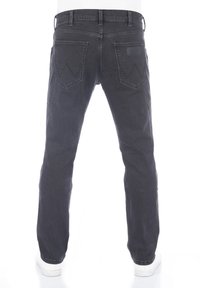 Jeans in denim nero con taglio dritto. Presentano due tasche posteriori con un design triangolare. Finiti con una patch in pelle sulla vita.