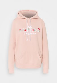 Jasnoróżowa bluza z kapturem, przednią kieszenią, białymi sznurkami oraz kwiatowym napisem "Hollister California". Miękka, delikatna tkanina.
